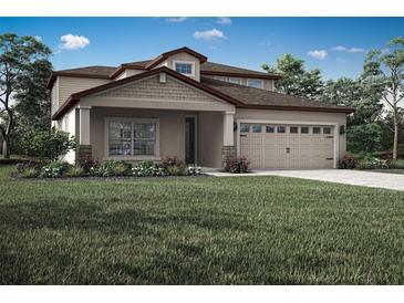 Charming two-story home with landscaped yard, covered porch and a two car garage at 3335 Chinotto Dr, Lake Alfred, FL 33850