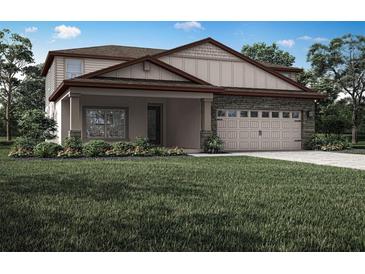 Charming two-story home with stone accents, a welcoming front porch, and attached two car garage at 3339 Chinotto Dr, Lake Alfred, FL 33850