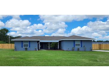 Charming single story home boasts a spacious front yard and a quaint covered entryway at 8804 Harrison Rd, Lakeland, FL 33810