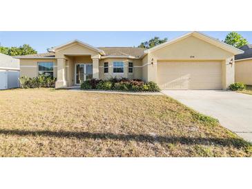 Charming single-story home with a two-car garage and well-maintained landscaping at 2138 Mirasol Dr, Winter Haven, FL 33881