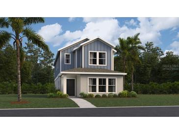 Charming two-story home showcasing a modern blue and grey exterior with lush landscaping and a welcoming entrance at 2105 Stake Out Way, Apopka, FL 32703