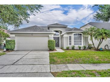 Charming single Gathering home with a well-maintained lawn, two car garage and beautiful landscaping at 2719 Osprey Creek Ln, Orlando, FL 32825