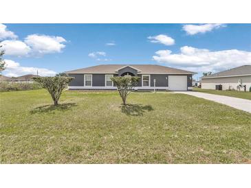 Charming single-story home with a well-maintained lawn and driveway on a beautiful sunny day at 326 Marion Oaks Trl, Ocala, FL 34473
