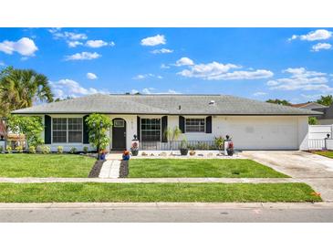 Charming single-story home featuring well-kept landscaping and a welcoming front entrance at 1913 Poinsetta Ln, Maitland, FL 32751