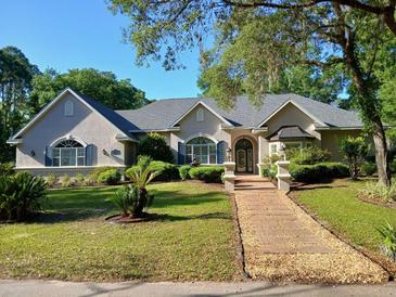 Charming single-story home featuring a landscaped front yard and brick walkway at 19811 Lake Dorr Rd, Altoona, FL 32702