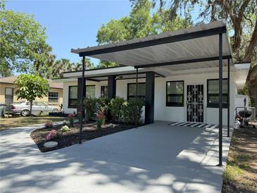 Charming home with a covered front and decorative front door offers curb appeal with its landscape at 635 Mccormick St, Daytona Beach, FL 32114