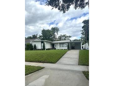 Charming home featuring a well-manicured lawn and a covered carport at 1105 Chichester St, Orlando, FL 32803