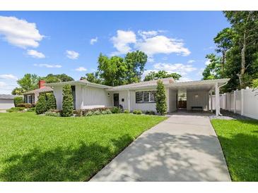 Beautiful single-story home featuring a carport and manicured lawn and front garden at 1105 Chichester St, Orlando, FL 32803