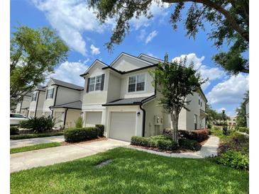 Beautiful townhouse with manicured lawn, driveway and attached garages in a desirable neighborhood at 6059 Twain St # 108, Orlando, FL 32835
