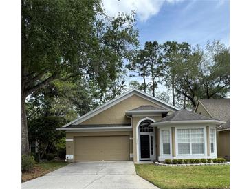 Charming single-Gathering home with well-manicured lawn and two-car garage at 1608 Fox Glen Ct, Winter Springs, FL 32708