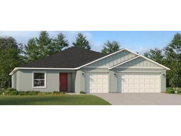 Charming single-story home with a two-car garage, well-maintained lawn, and welcoming curb appeal at 2115 Forage Dr, Kissimmee, FL 34746