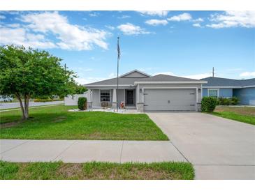 Charming single-Gathering home with a manicured lawn, two car garage and welcoming curb appeal at 305 St Georges Cir, Eagle Lake, FL 33839