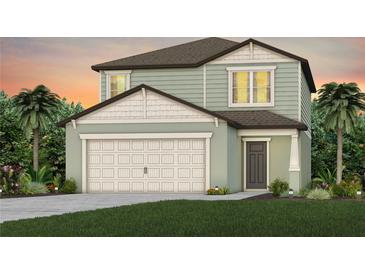Charming two-story home with a two-car garage, landscaped yard, and classic architectural details at 9052 Wildlight Trl, Wildwood, FL 34785