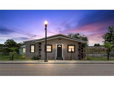 Charming home featuring a cozy front porch, meticulous landscaping, and a classic lamp post at 1101 Dr Martin L King Jr Way, Haines City, FL 33844