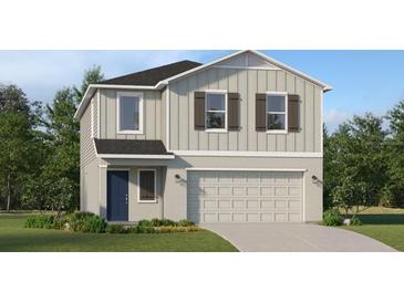 Charming two-story home featuring vertical siding, decorative shutters, attached two car garage, and manicured lawn at 3403 Howell Dr, Lake Wales, FL 33859