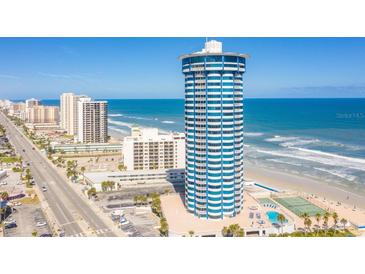 Stunning exterior view of the beachfront condominium tower with ocean views and surrounding city buildings at 2625 S Atlantic Ave # 24Sw, Daytona Beach, FL 32118
