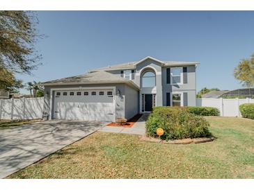 Charming two-story home with a well-maintained lawn and a spacious two-car garage at 1808 Ashton E Dr, St Cloud, FL 34771