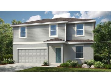 Charming two-story home with a combination of gray siding and stone, complemented by a well-manicured lawn at 2302 Cypress Creek St, Auburndale, FL 33823