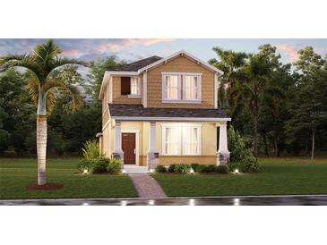 Charming two-story home featuring a textured facade, inviting front porch, and manicured landscaping at 1888 Bright Sky Dr, Kissimmee, FL 34744