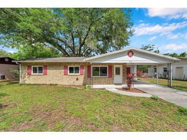 Charming single-story brick home with red shutters and carport at 1123 Enchanted Dr, Lakeland, FL 33801