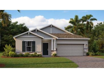 Charming single-story home with a two-car garage, well-maintained lawn, and beautiful landscaping at 2853 Haze Rd, Clermont, FL 34714