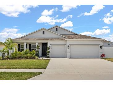 Charming single-story home showcasing a well-manicured lawn and a spacious three-car garage at 921 Fieldstone Way, Haines City, FL 33844