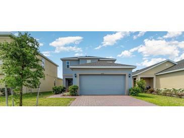 Charming two-story home featuring a two-car garage and a well-maintained front yard at 6889 Wilson Hammock Ave, Groveland, FL 34736