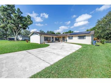 Charming single-story home featuring well-maintained lawn, large driveway, and solar panels at 4821 S Gachet Blvd, Lakeland, FL 33813