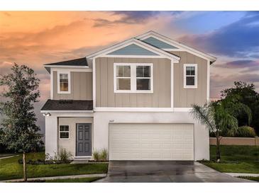 Charming two-story home featuring a two-car garage and attractive landscaping at 1748 Frogmore Ave, Haines City, FL 33844