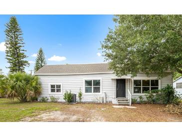 Charming single-story home featuring a neatly landscaped yard and a welcoming front entrance at 1002 Ne 1St St, Mulberry, FL 33860