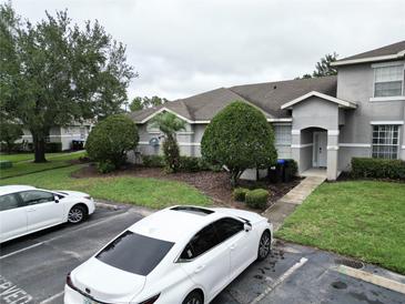 Well maintained townhouse featuring manicured landscaping and reserved parking at 13140 Summerton Dr, Orlando, FL 32824