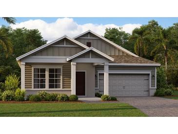 Charming single-Gathering home featuring a two-car garage, well-manicured lawn, and craftsman-style architecture at 617 Terrapin Dr, Debary, FL 32713