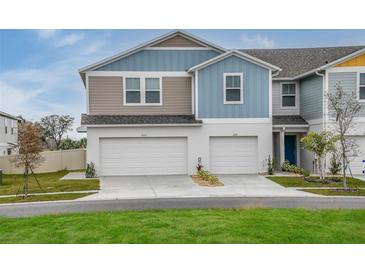 Charming townhome featuring a two-car garage and modern exterior design at 3782 King Hill Dr, Haines City, FL 33844