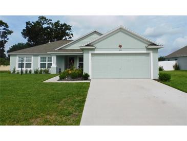 Charming one-story home boasts a manicured lawn and attached two-car garage at 206 Samantha Ave, Auburndale, FL 33823