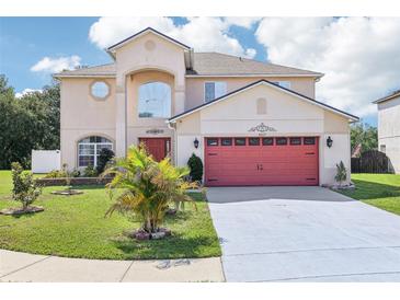 Charming two-story home featuring a well-manicured lawn, mature landscaping and a two car garage at 4422 Evergreen Forest Loop, Kissimmee, FL 34758