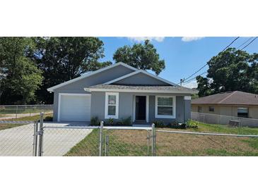 Charming single-story home featuring a well-maintained lawn and a classic architectural design at 1318 Herschell St, Lakeland, FL 33815