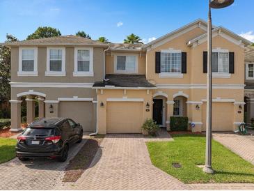 Charming townhome featuring a brick-paved driveway and attached garages, perfect for comfortable living at 2417 Passamonte Dr # 1E, Winter Park, FL 32792