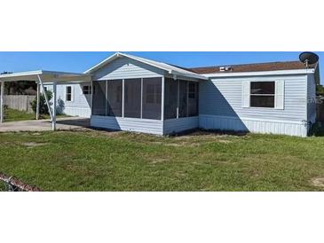 Charming single Gathering home featuring a screened lanai and spacious carport at 4300 Meadow Ridge Ave, Mulberry, FL 33860