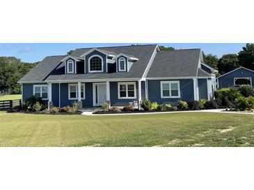 Charming two-story home boasts a manicured lawn and classic architectural details at 6726 Nw 54Th Loop, Ocala, FL 34482