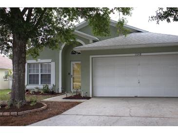 Charming one-story home with a well-maintained lawn and attached two-car garage at 1048 Winding Water Way, Clermont, FL 34714