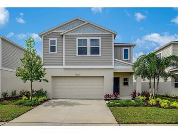 Inviting two-story home with a well-manicured lawn and attached two-car garage at 4035 Gardenia Ave, Lake Hamilton, FL 33851