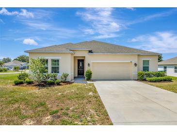 Charming single-story home with a well-maintained lawn and a two-car garage at 1803 Daybreak Dr, Fruitland Park, FL 34731