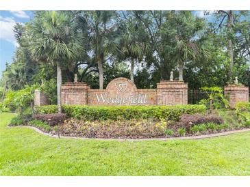 Wedgefield community sign with palm trees and manicured landscaping at the entrance at 2524 Albion Ave, Orlando, FL 32833