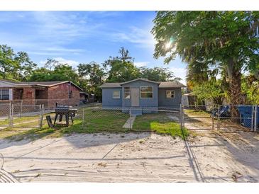 Charming single-story home with a fenced front yard and mature trees at 1224 S Delaware Ave, Deland, FL 32720