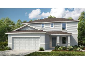 Charming two-story home with a white garage door and inviting curb appeal at 2076 Babbling Brook Blvd, Auburndale, FL 33823