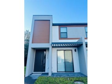 Modern two-story home with minimalist landscaping and striking architectural details at 3428 Tranquil Trail, Kissimmee, FL 34747