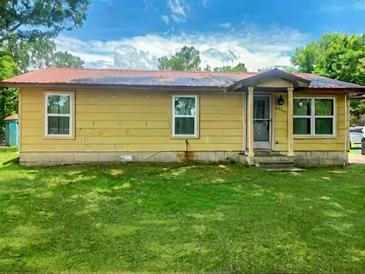 Quaint single-story home with a red roof, awaiting your personal touch at 2220 Woods Trl, Lakeland, FL 33809