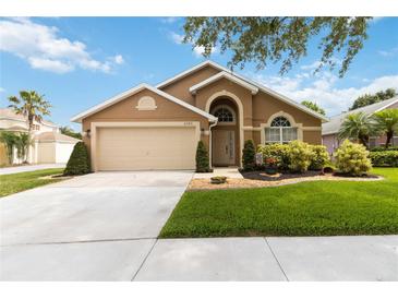 Charming single-story home with a well-maintained lawn and two-car garage at 8360 Lake Amhurst Trl, Orlando, FL 32829