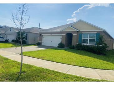 Charming single-story home with a well-manicured lawn and attached two-car garage, and neutral color scheme at 3974 Mekong Ct, St Cloud, FL 34772