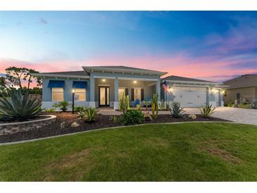 Charming single-story home features a well-manicured lawn, desert landscaping, and a three-car garage at 10298 Sw 96Th Loop, Ocala, FL 34481